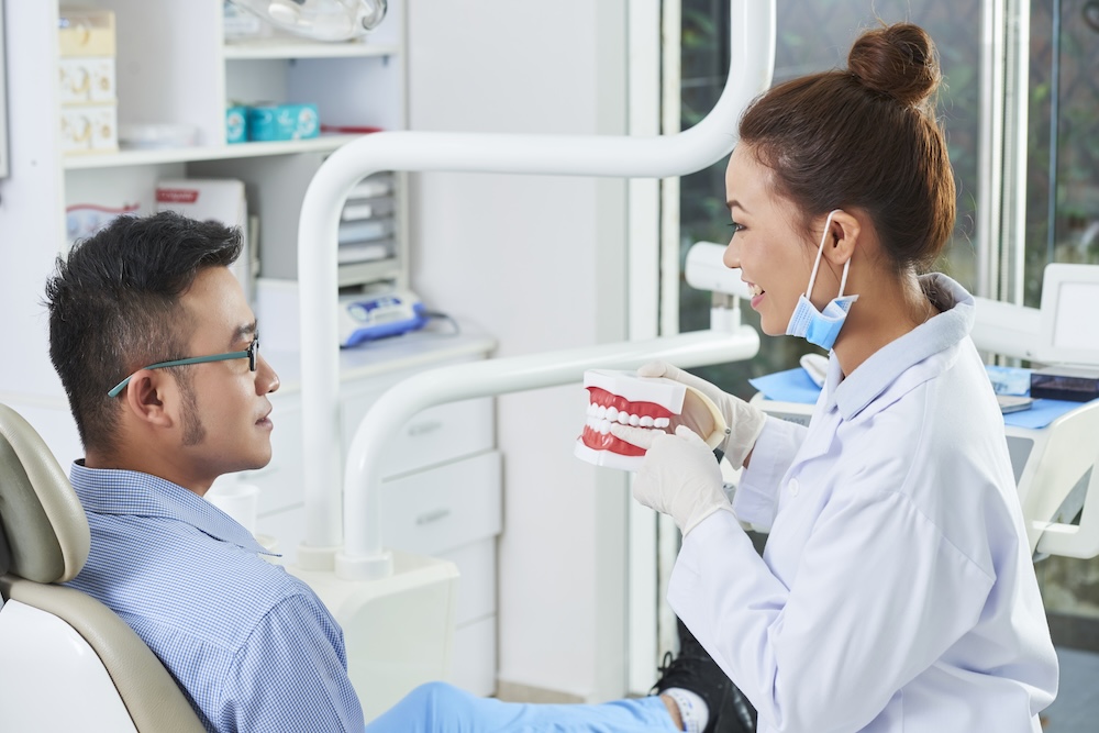 a dentist explaining dental implants to a patient